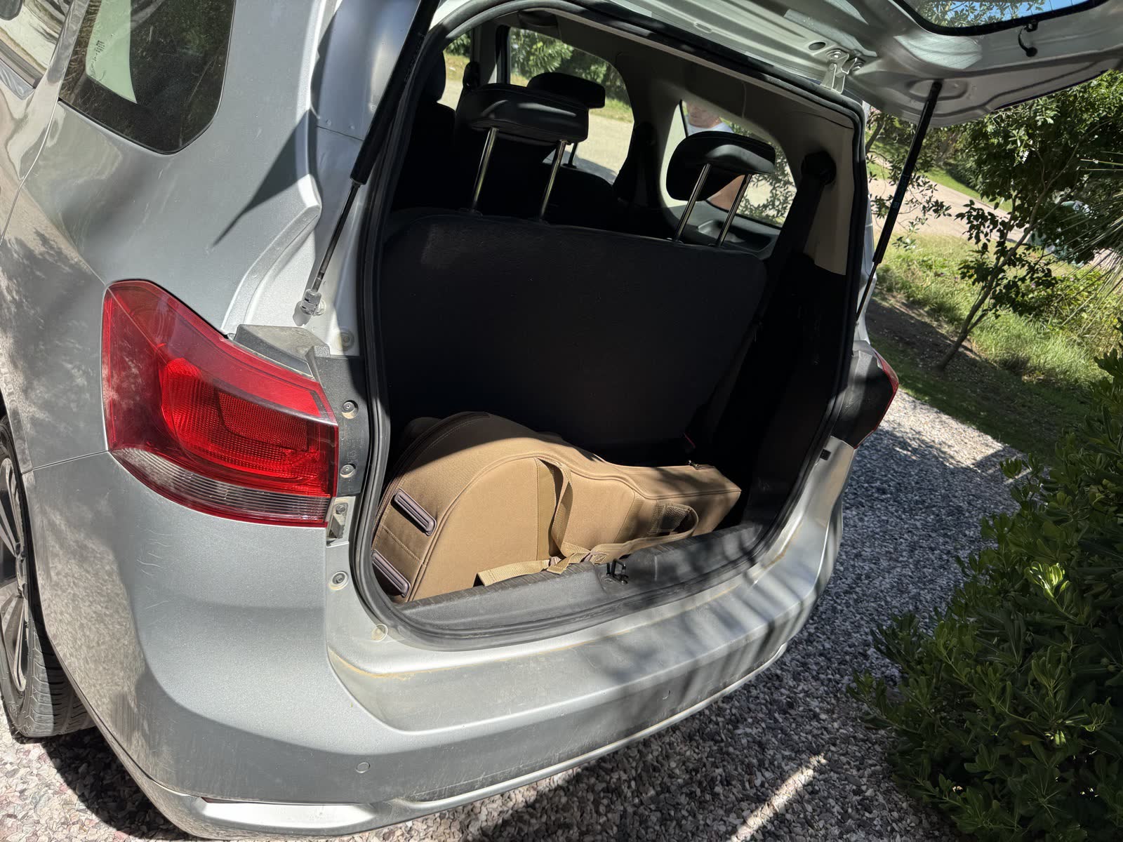 Taylor GS Mini gig bag fitted in the trunk of a small rental hatchback in Uruguay